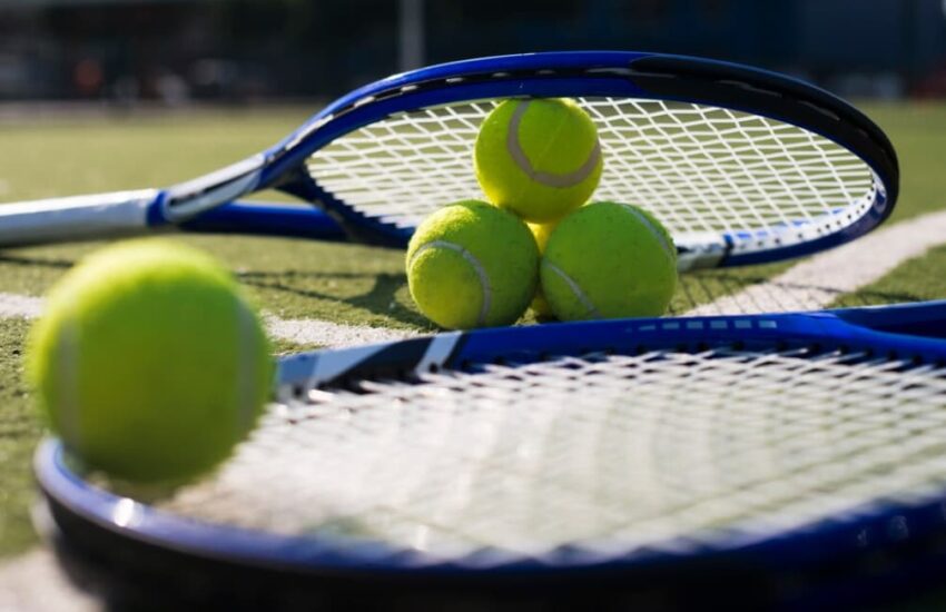 Tennis rackets and balls on grass court