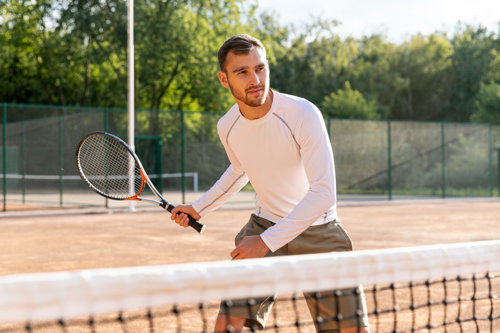 Front view man playing tennis