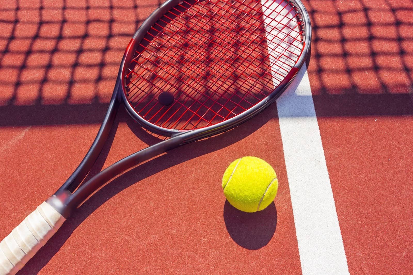 a tennis ball and racket on the court